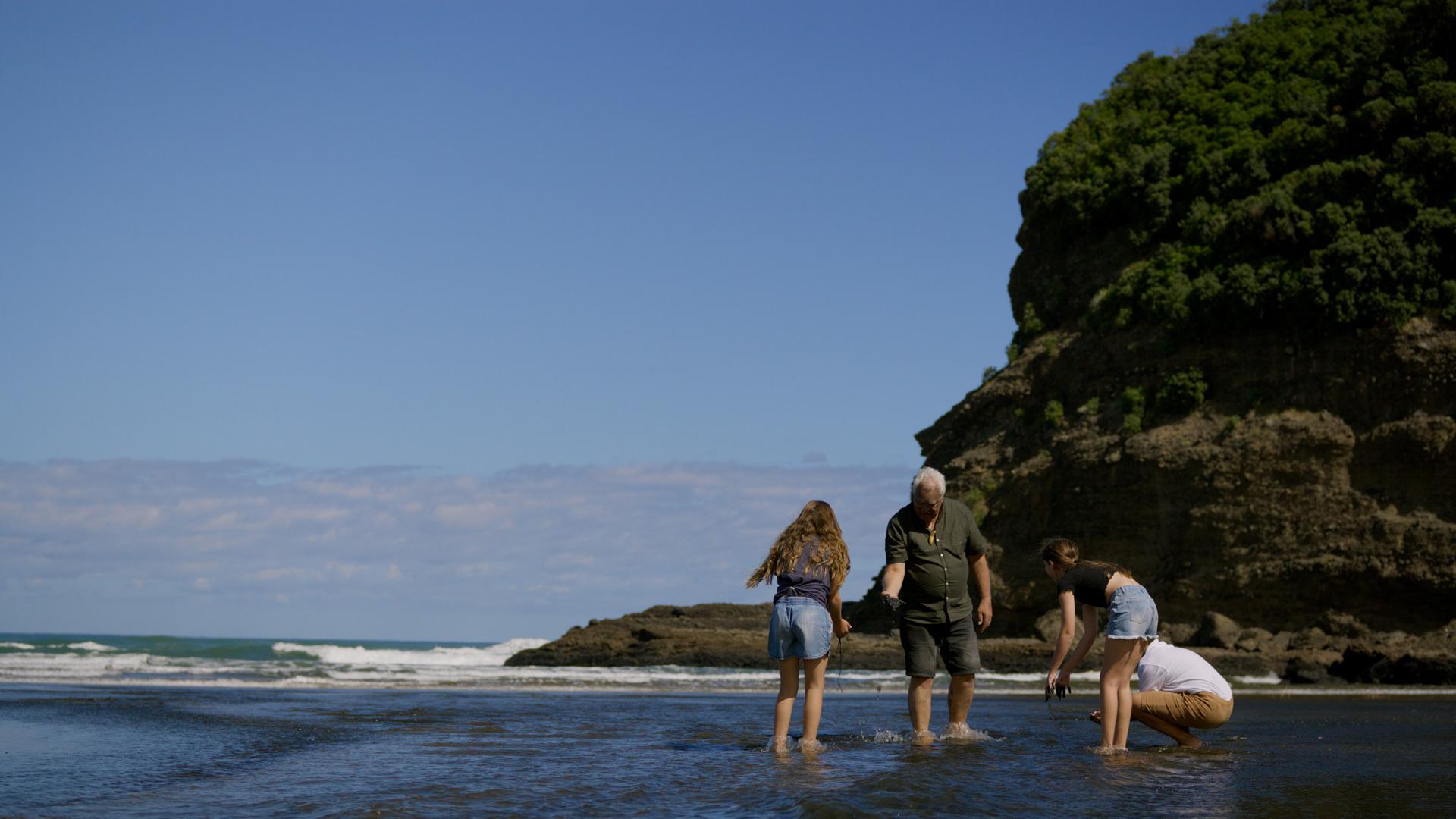 Image of Joe on the beach with children